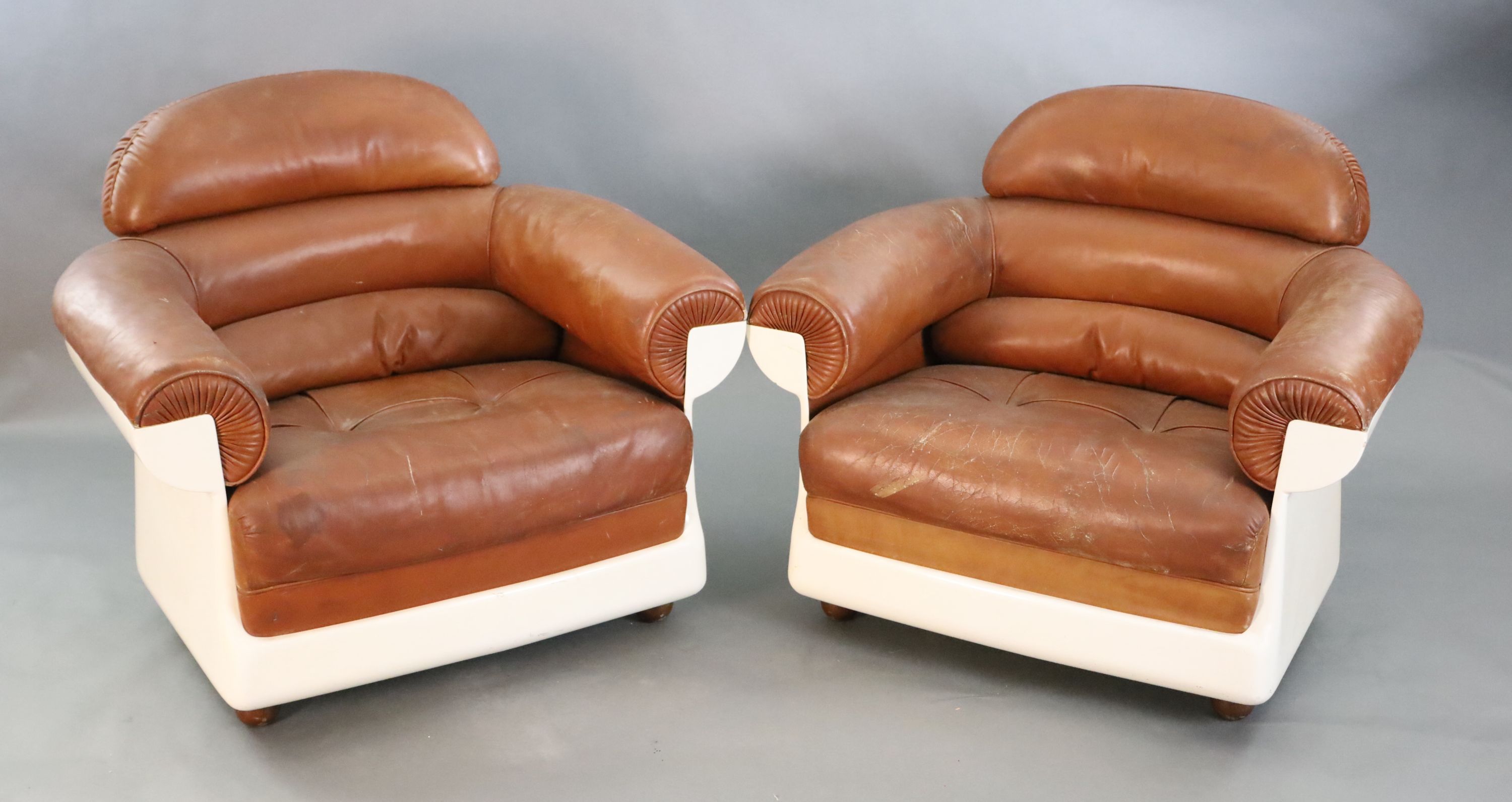 A pair of mid century tan leather and fibreglass tub chairs, possibly French, by Airbourne, width 90cm, depth 75cm, height 78cm